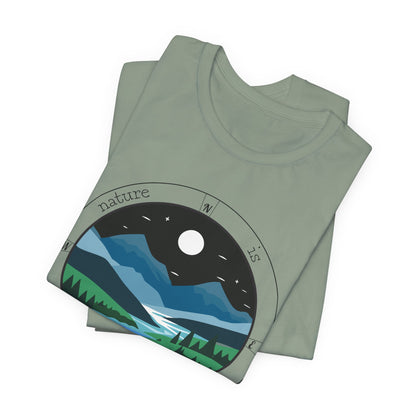 Folded green t-shirt with nature graphic design on a white background