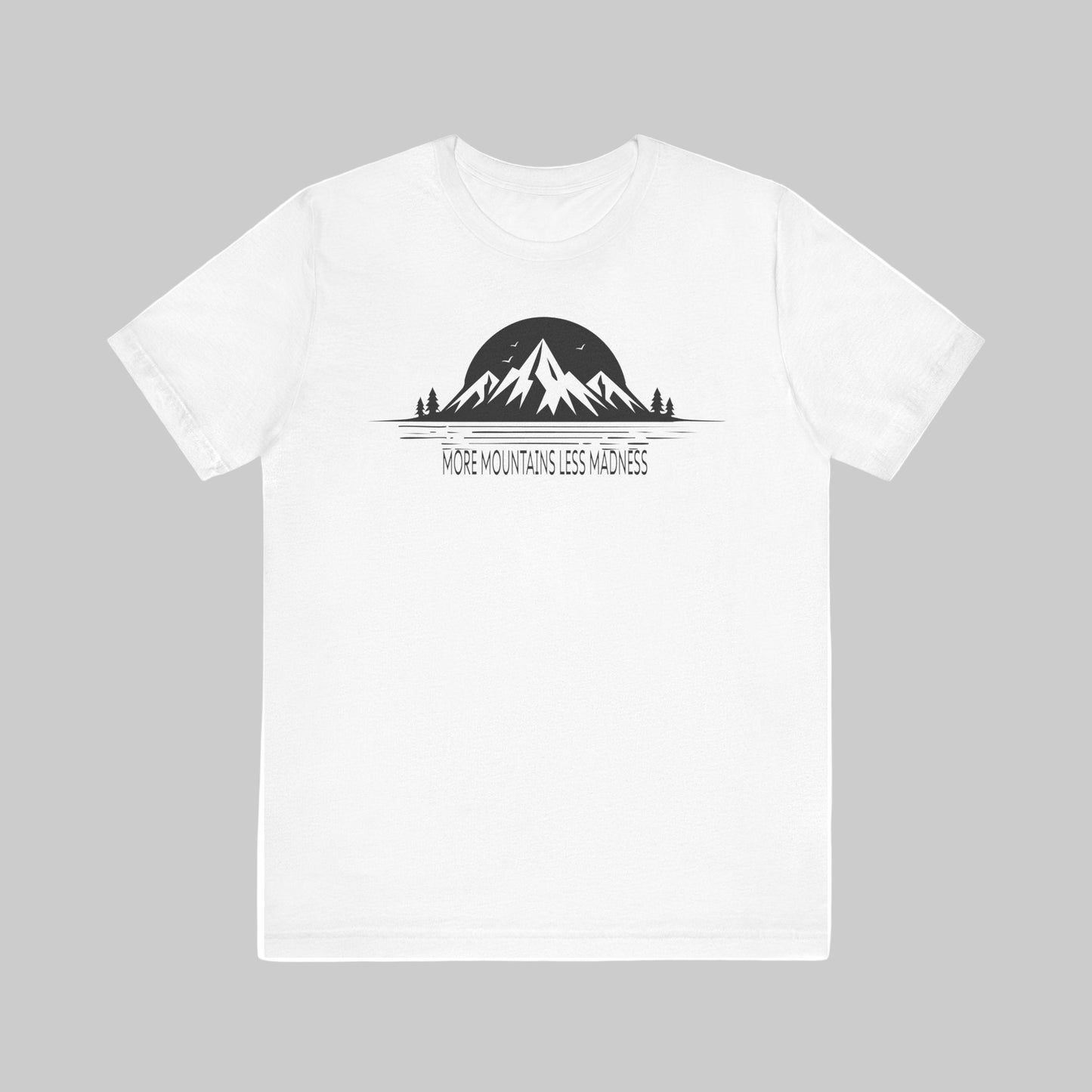 White t-shirt with mountain graphic and text 'More Mountains Less Madness' on a white background
